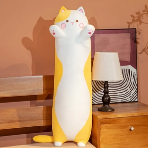 Detail of cute long cat plush pillow featuring pink paw prints in a cozy bedroom setting