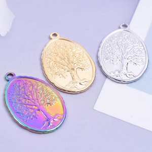 Rainbow, gold, and silver oval Tree of Life pendants on a purple background