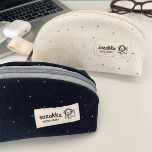 Polka dot wool pencil pouches in cream and navy with portable handle and dog label