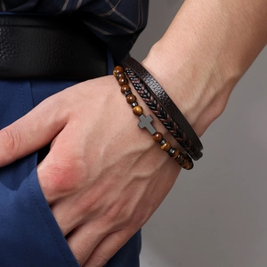 Multilayer men's cross bracelet with tiger eye stone and braided leather on wrist