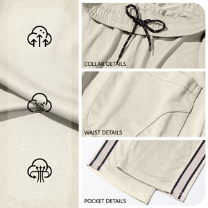 Beige men's loose sports shorts with drawstring waist, pockets and side stripes
