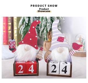 Detail of wooden Christmas gnome calendars with red and purple hats for desktop decor