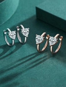 Detail view of heart-shaped S925 sterling silver hoop earrings with zircon stones
