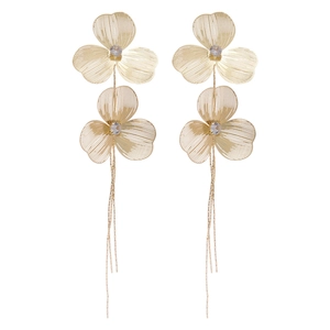 Elegant gold hollow flower tassel earrings with sparkling cubic zirconia on white background