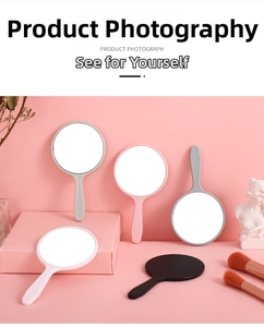 Detail shot of handheld mini mirrors in five pastel colors with ergonomic round handles