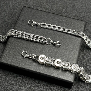 Three styles of silver hip-hop Cuban link chain bracelets for men on a black jewelry box