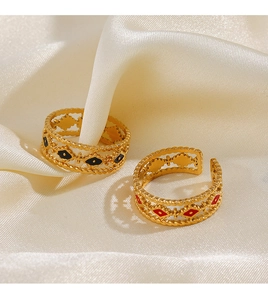 Detailed shot of openwork braided gold rings with colorful enamel diamond motifs