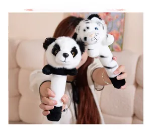 Detailed close-up of plush panda and white tiger handheld dolls with soft furry texture