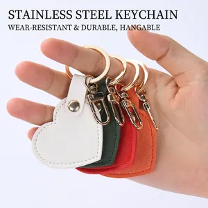 Handheld heart-shaped leather keychains in white, green, red and orange with steel rings