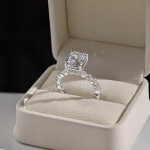 Close-up of S925 silver ring with rectangular zircon in a beige jewelry box