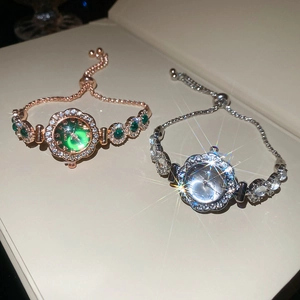 Close-up of rose gold and silver quartz bracelet watches with crystal inlay in a gift box