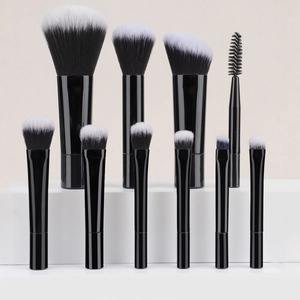 Close-up of 10-piece portable makeup brush set with black handles and bicolor bristles
