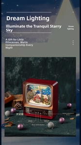 Detail of vintage red TV music box with light, volume knobs and Christmas snow scene