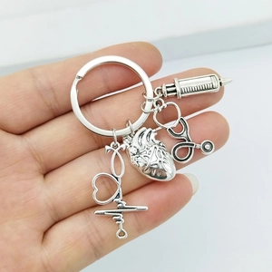 Detailed close-up of nurse medical keychain with syringe, stethoscope and heart pendants