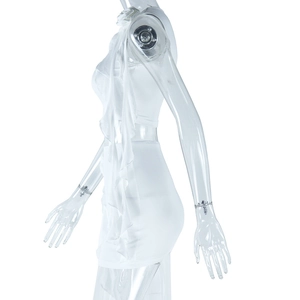 Detail of white two-piece skirt set showing ruffled side drapes on the mini skirt