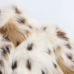 Macro view of plush faux fur texture with leopard print pattern on a warm winter jacket