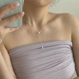 Y-shaped 925 sterling silver necklace with zircon and pearl charm worn on the neckline