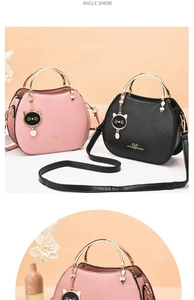 Detail view of pink and black seashell bags with metal handles and cat charms