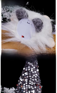 Detail view of glowing Christmas gnome bottom battery compartment and silver sequin hat