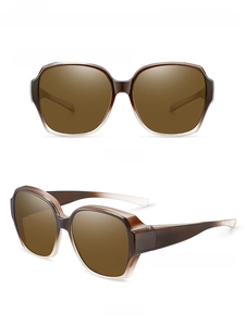 Close-up of translucent brown oversized sunglasses with polarized tawny lenses for women