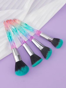 Detail of colorful crystal makeup brushes with vibrant green tips and faceted handles