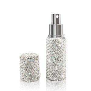 Sparkling rhinestone-encrusted 10ml travel perfume spray bottle on a white background