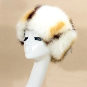 Close-up of thick faux fox fur winter hat in white with brown spots on a model stand