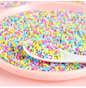 Gros plan de vermicelles colorés en pâte polymère dans une cuillère pour déco DIY
