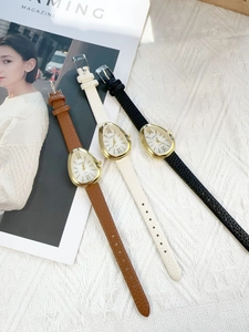 Three quartz watches with water drop cases and leather straps on textured fabric
