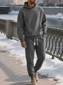Detail of men's dark grey hooded tracksuit with textured diamond knit pattern