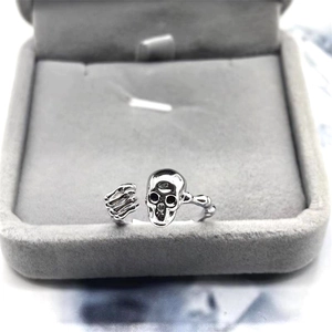 Minimalist S925 sterling silver skull and bone open ring displayed on velvet box
