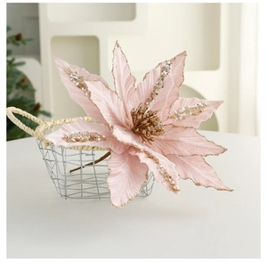 Pink artificial Christmas poinsettia with gold glitter and silver sequins in a basket