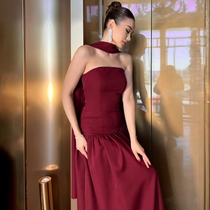 Detail of burgundy backless tube dress with matching halter neck scarf and smooth fabric