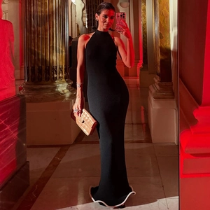 Detail of a backless halter neck black mermaid dress with ruffled hem and slim fit cut