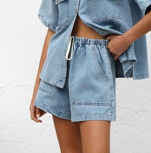 Close-up of light blue denim set showing pocket details and high-quality twill texture