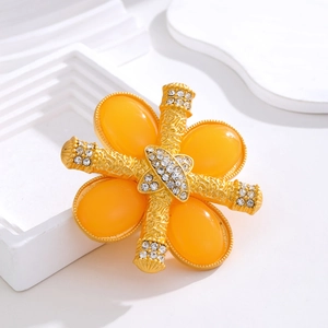Baroque floral brooch with yellow resin stones and intricate rhinestone accents