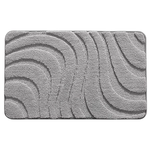 Absorbent grey bath mat with wave textured plush surface and non-slip backing