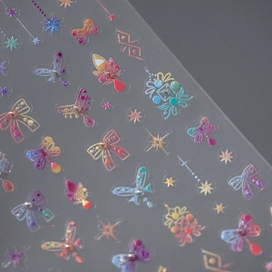 5D holographic 3D nail stickers featuring bows and butterflies on transparent sheet