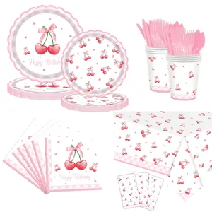 Pink cherry party tableware set with plates, cups, and napkins on a plaid tablecloth