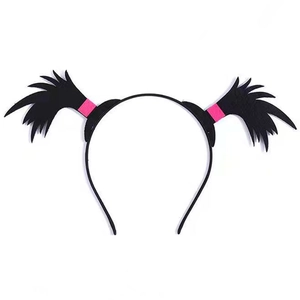 Detail of Halloween devil horn headband with black feathers and pink base accents