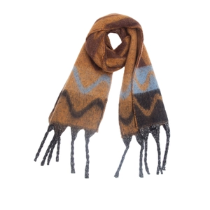 Detail view of knitted wavy geometric pattern and thick tassels on brown winter shawl