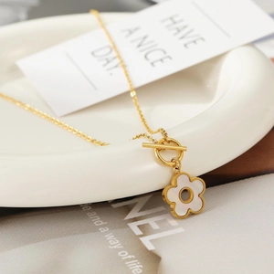 Golden titanium steel necklace featuring a white flower pendant and stylish OT toggle clasp