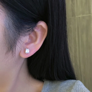 Close-up of S925 sterling silver earring with square-cut zircon on a female model's ear