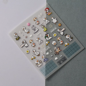 Detail of 5D embossed nail art stickers featuring funny cartoon ducks and textured patterns