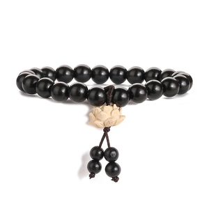 Polished black rosewood prayer beads bracelet with a white carved lotus flower pendant