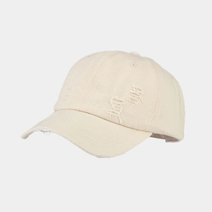 Detailed view of beige washed canvas baseball cap featuring distressed torn holes