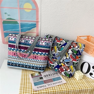 Large canvas tote bags with colorful geometric and sneaker prints and sturdy grey handles