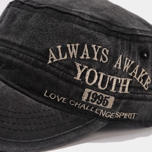 Detailed close-up of vintage washed cotton military cap with premium embroidery