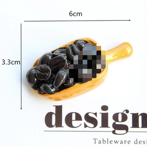 Miniature yellow coffee bean spoon decorative magnet measuring 6cm by 3.3cm