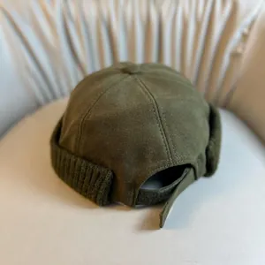 Army green Miki Hat with knitted brim and adjustable velcro strap on cream fabric